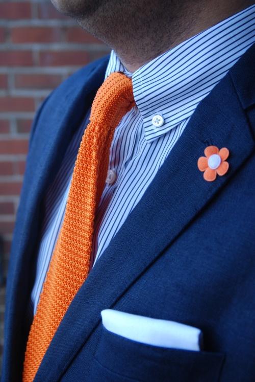 An Orange Tie against a Blue Shirt can great a bold look! This is an example of a complementary color scheme at its best! Courtesy of www.pinterest.com