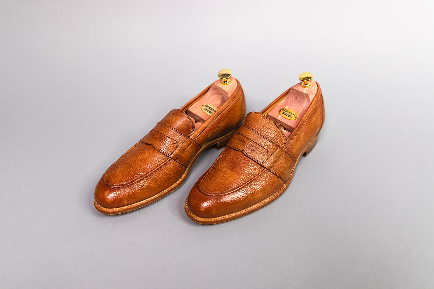 tan leather loafers from Herring facing left on gray background