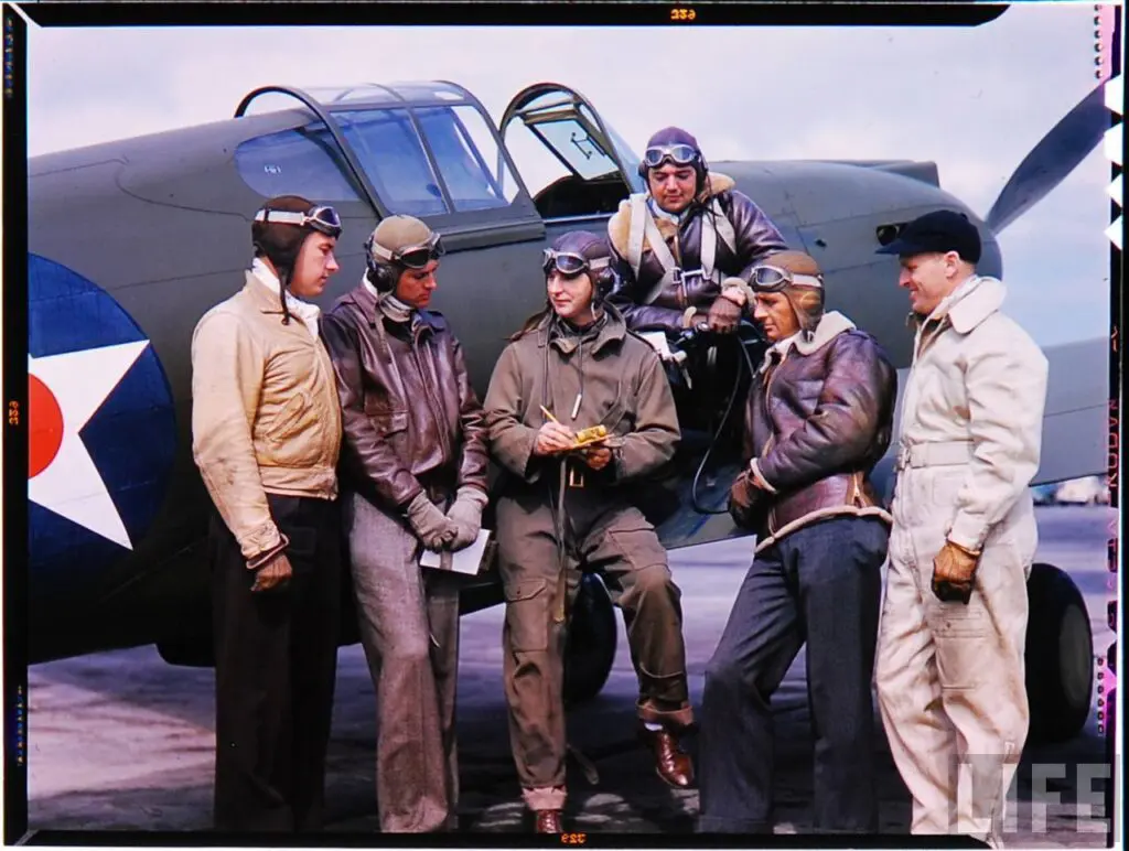 vintage photo men wearing flight jackets next to a plane