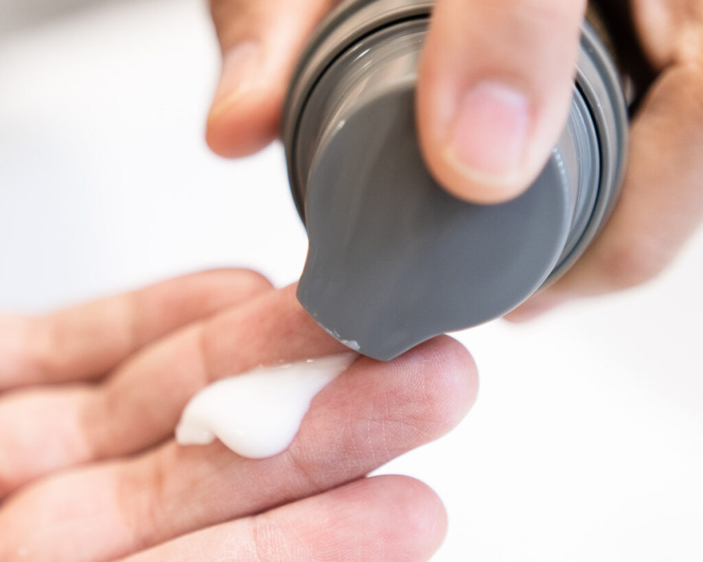 facial moisturizer squeezed out of bottle
