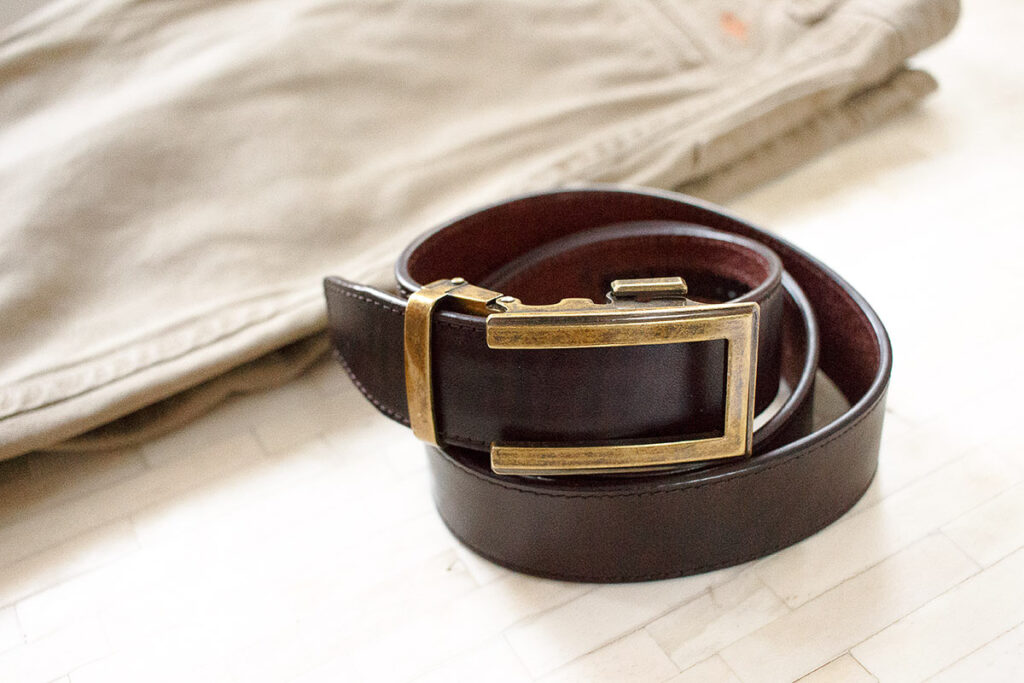 the ultimate of men's accessories - brown belt and partial display of khaki pants