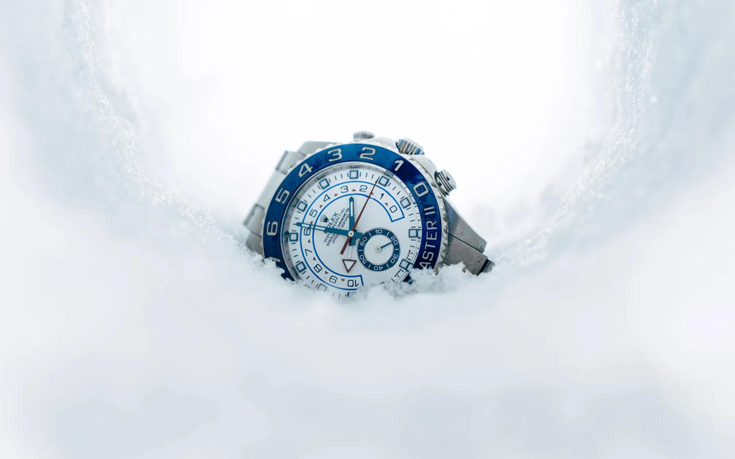 white dial rolex yacht master with blue bezel in snow