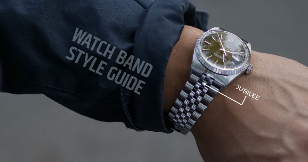 Arm mit marineblauem Jackenärmel und Rolex-Armbanduhr aus Stahl