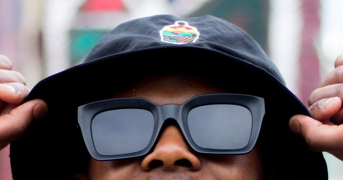 man wearing black bucket hat and black sunglasses