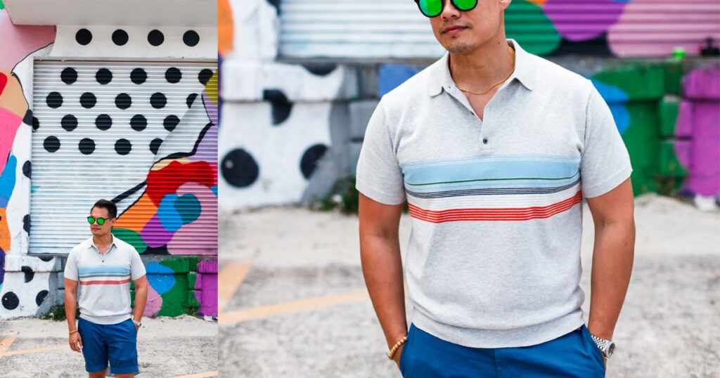 asian man wearing grey polo with multi colored stripes