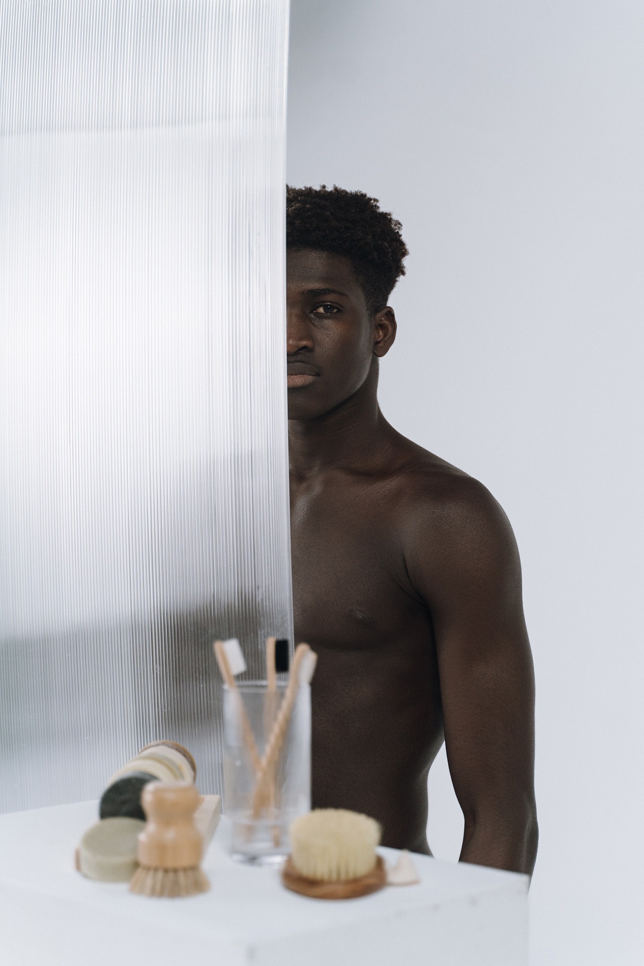 man standing behind shower curtain