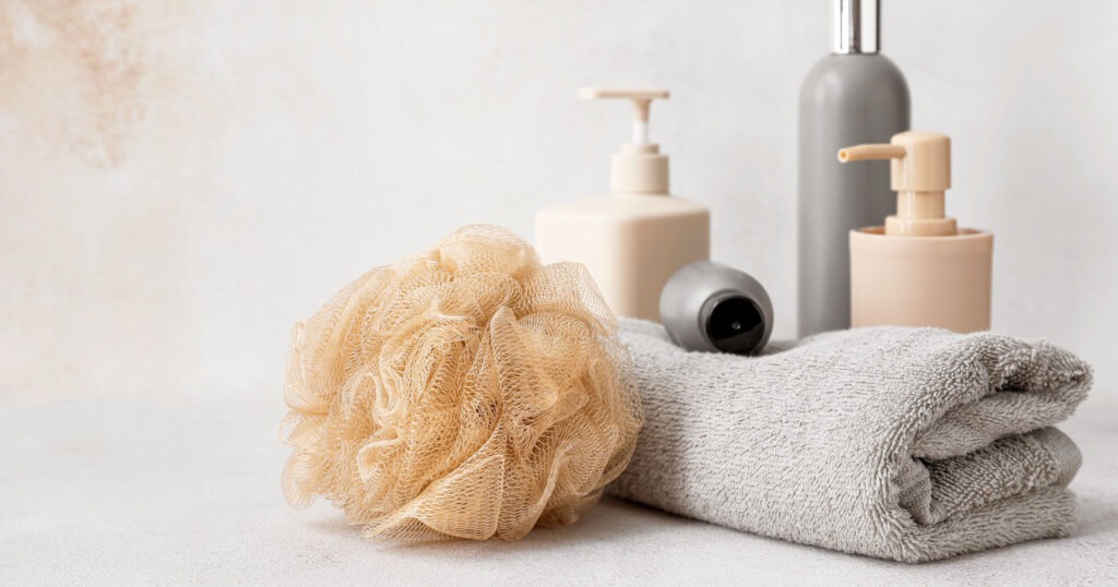 loofah towel soaps and other bath essentials on a table
