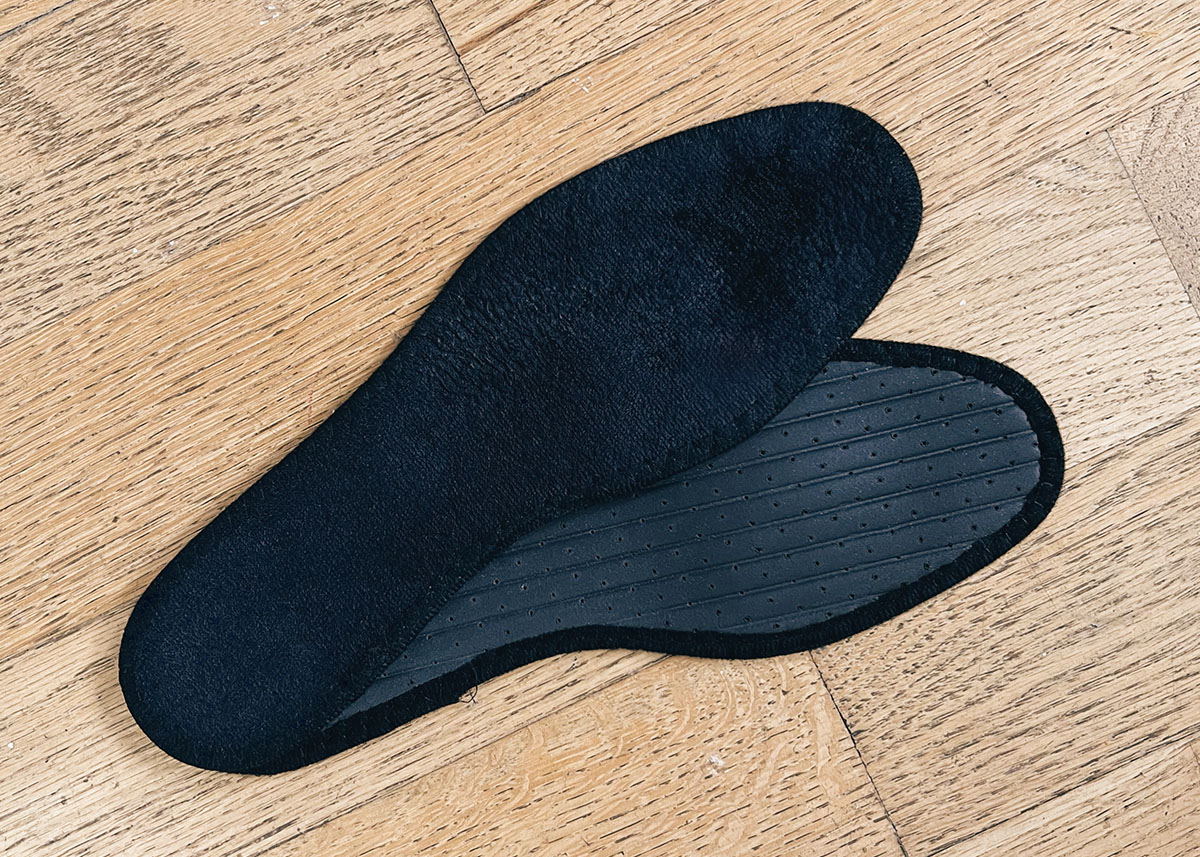 black pedag insole pair on wood floor