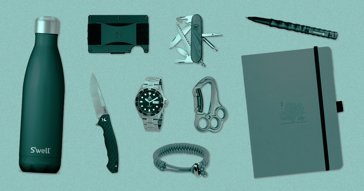 flatlay of everyday carry items on blue background