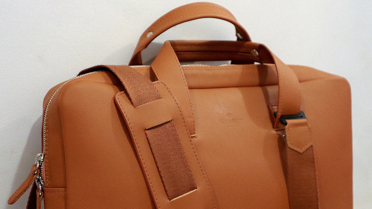 close up of tan leather bag strap