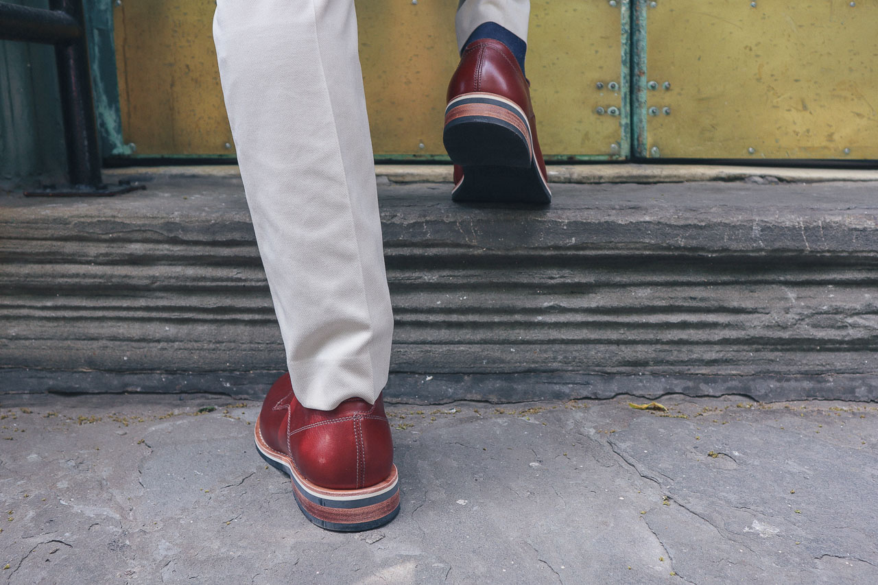 closeup of man walking up stairs in brown derby shoes