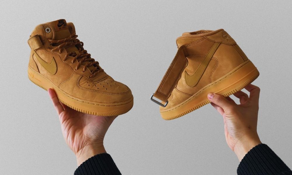 nike air force 1 mid in wheat held in hand